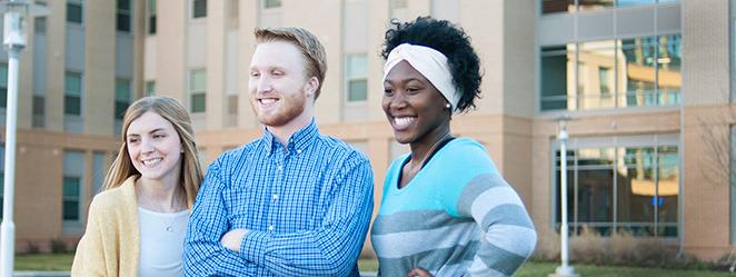 Student smiling in front of Mashburn Hall